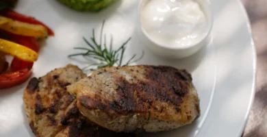 Plated grilled chicken dish with sides