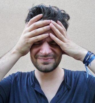 Person with a headache holding their forehead