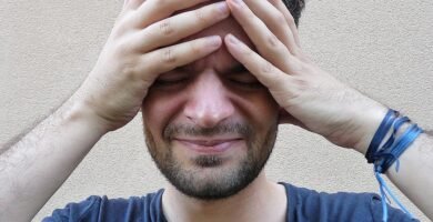 Person with a headache holding their forehead