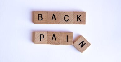 Person holding lower back due to back pain