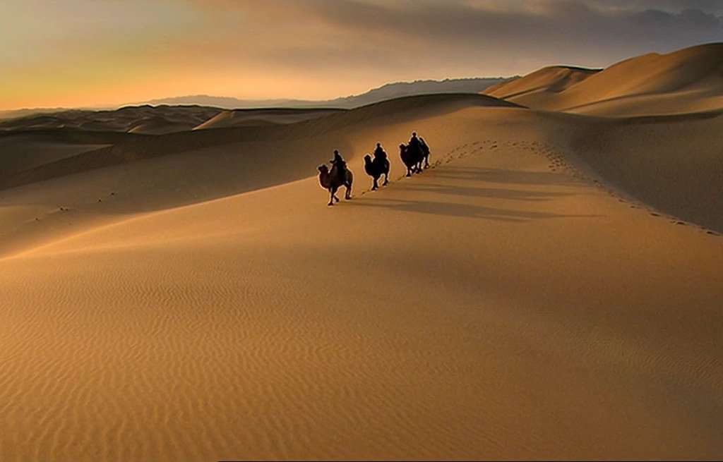 Camel caravan crossing the desert along the ancient Silk Road