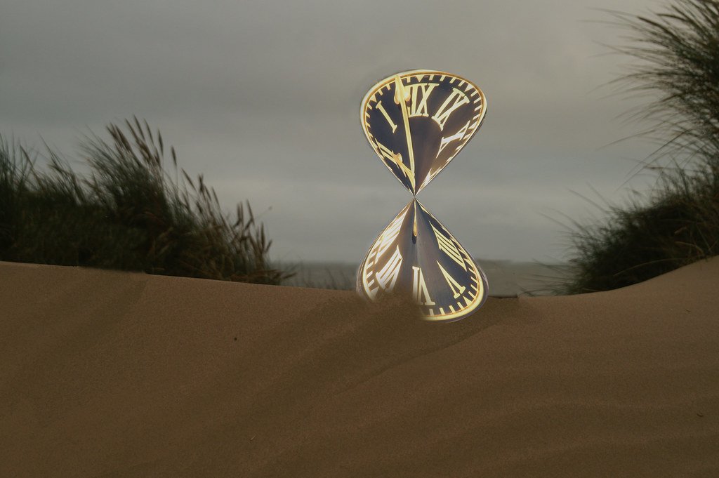 Hourglass on a desk representing time passing