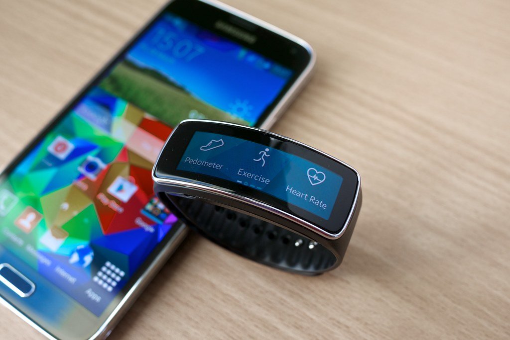 Smartwatch on a wrist showing a health and fitness data screen