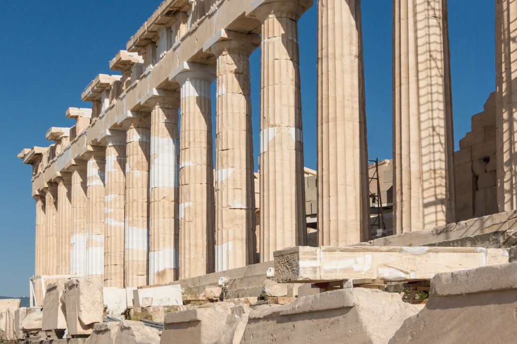 Columns of the Parthenon at the Acropolis of Athens against a blue sky