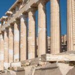 Columns of the Parthenon at the Acropolis of Athens against a blue sky