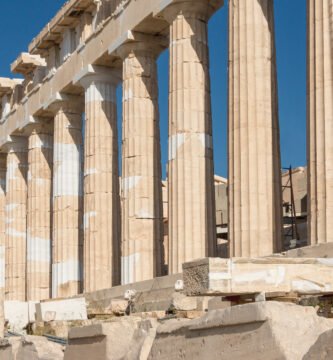 Columns of the Parthenon at the Acropolis of Athens against a blue sky